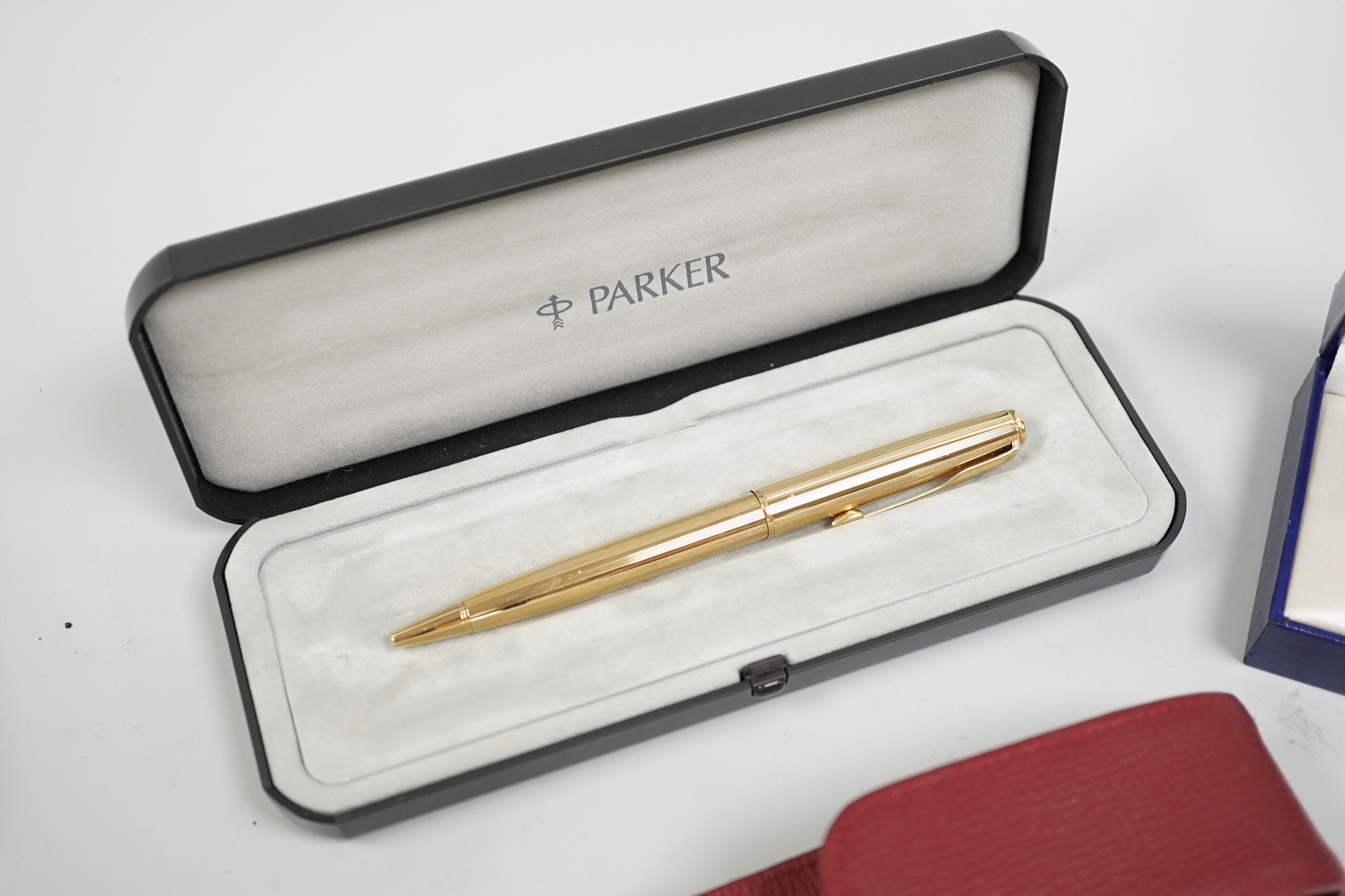 Three Parker pens and a Waterman pen